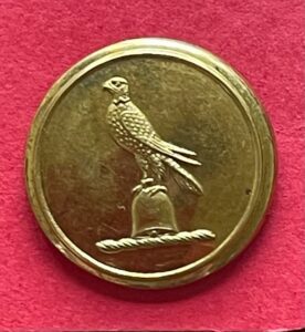 Armorial livery button with a crest of a hawk on a bell, 25mm gilt