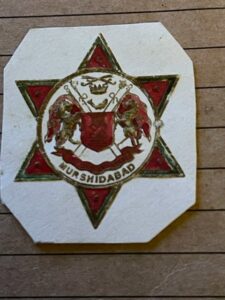 MURSHIDABAD. Coloured wnd embossed coat of arms