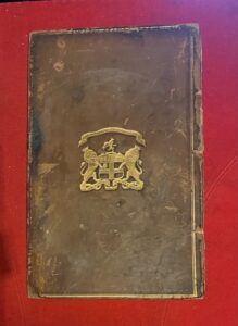 East India College. Antique leather bbok board with the arms of the college in gilt.